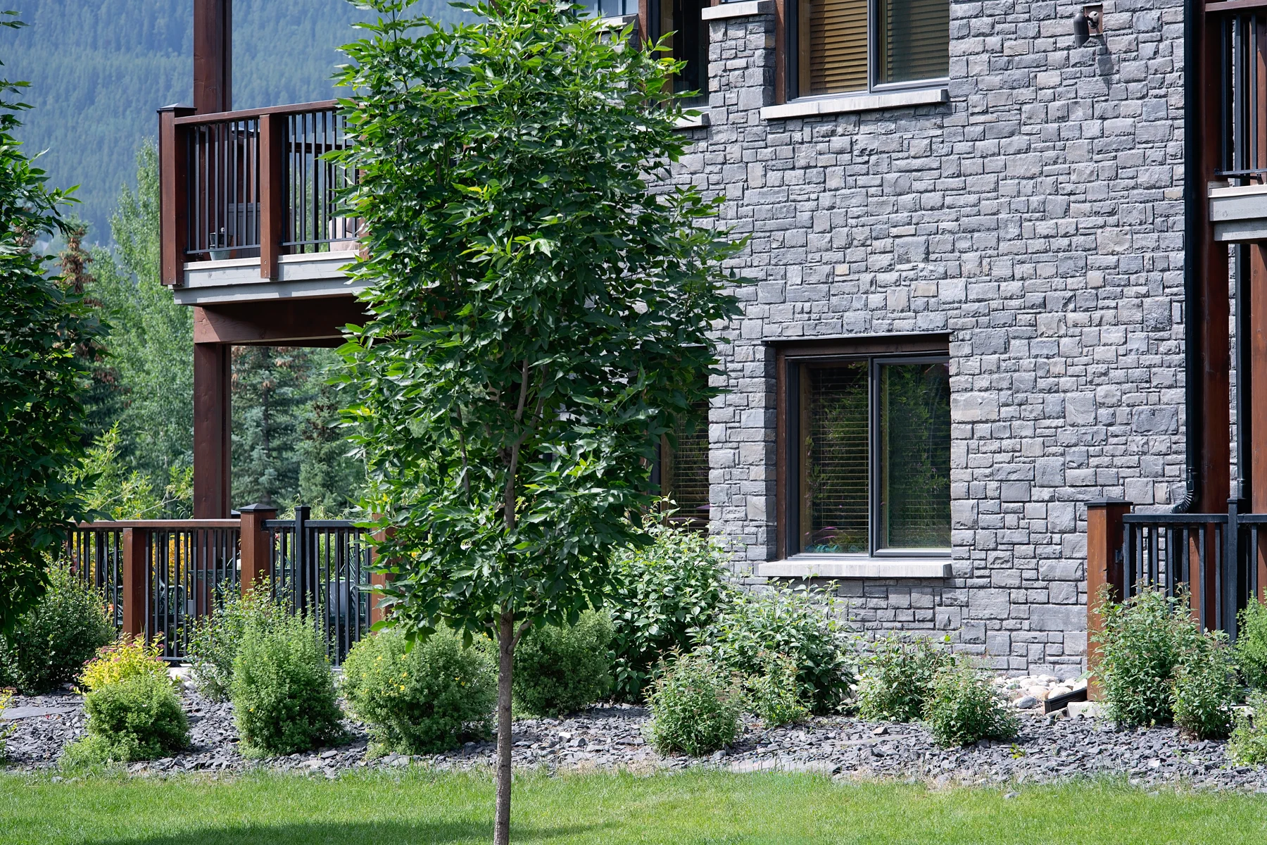 Stone facade and landscaping at Jack Pine Lodge